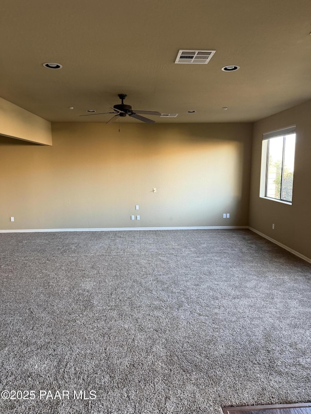 spare room with carpet floors and ceiling fan