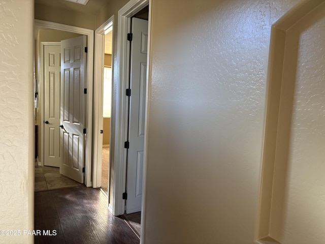 corridor with dark hardwood / wood-style floors