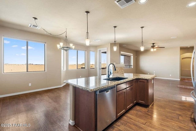 kitchen featuring dark wood finished floors, visible vents, dishwasher, and a sink