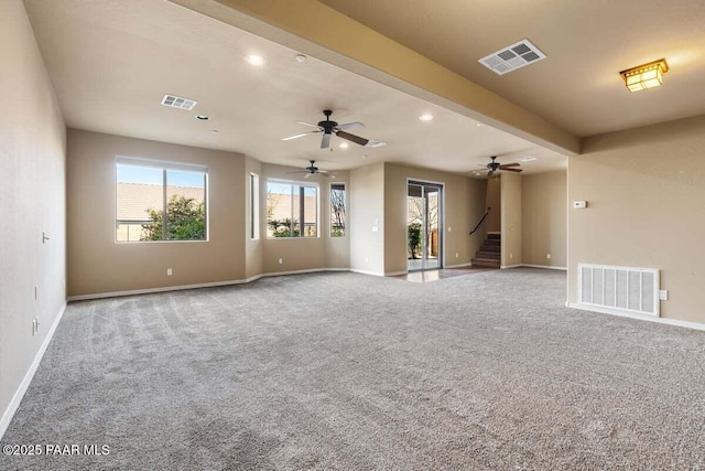 unfurnished room with visible vents, carpet flooring, and stairs