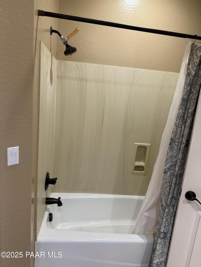 bathroom with shower / bath combination with curtain