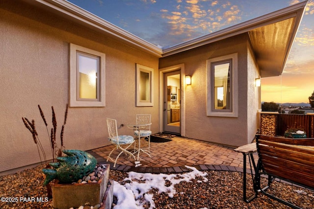 exterior space with a patio and stucco siding