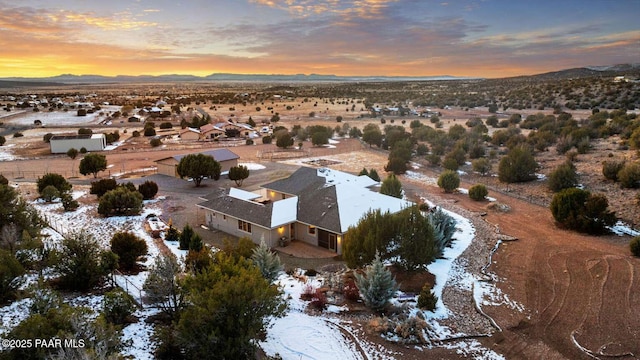 aerial view at dusk featuring a mountain view