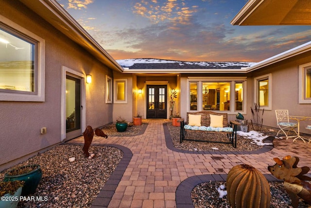 patio terrace at dusk featuring french doors