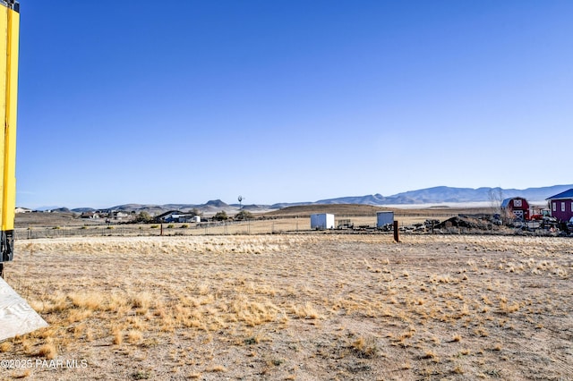 view of yard with a mountain view and a rural view