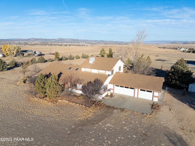 birds eye view of property featuring a mountain view and a rural view