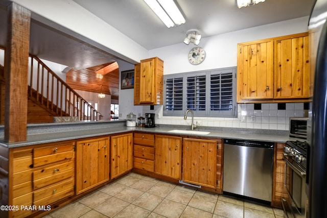 kitchen featuring light tile patterned floors, backsplash, stainless steel appliances, and sink