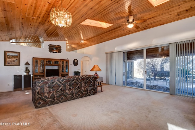 carpeted living room featuring a skylight, ceiling fan, high vaulted ceiling, and wooden ceiling