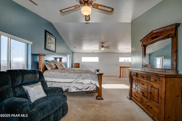 bedroom with light colored carpet, ceiling fan, and lofted ceiling