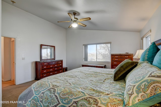 carpeted bedroom with ceiling fan and vaulted ceiling