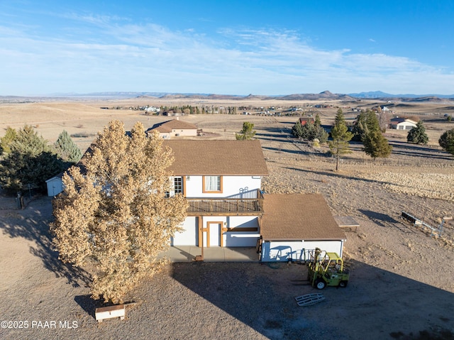 birds eye view of property with a mountain view and a rural view