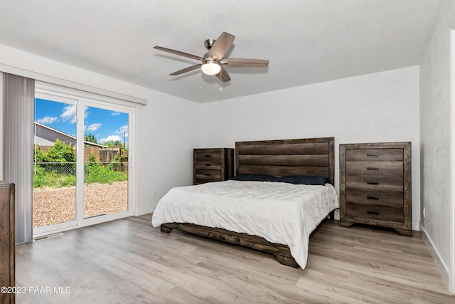 bedroom with ceiling fan, access to exterior, and light hardwood / wood-style flooring