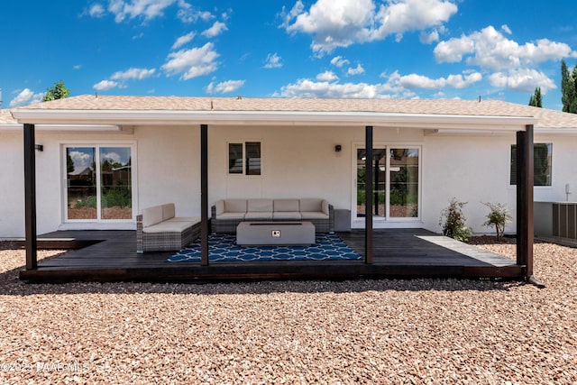 rear view of property featuring outdoor lounge area and a wooden deck