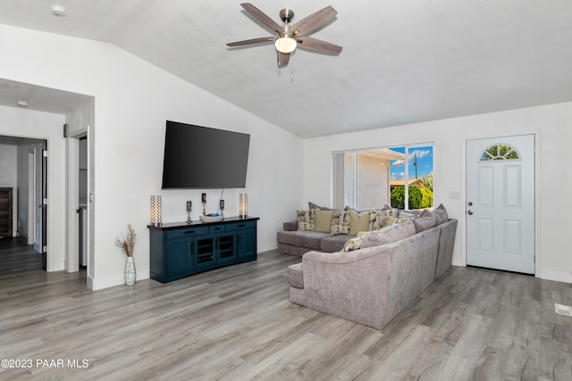 living room featuring light hardwood / wood-style flooring, ceiling fan, and lofted ceiling