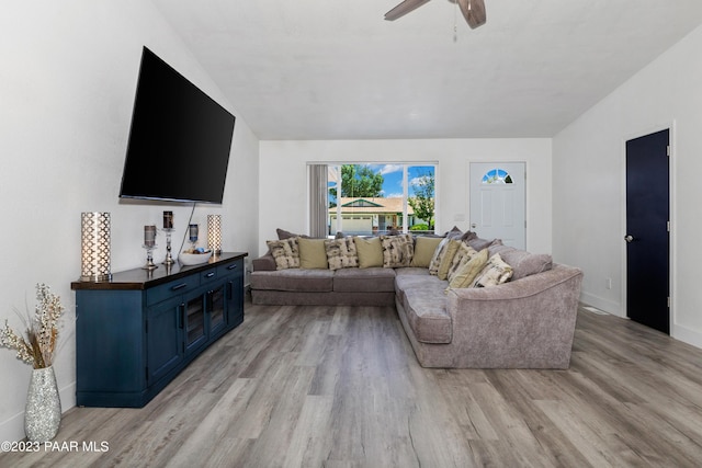 living room with light hardwood / wood-style floors and ceiling fan