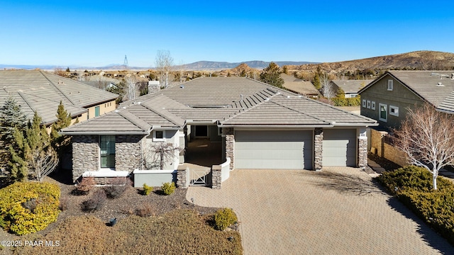 view of front of home with a garage and a mountain view