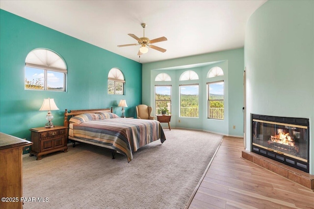 1330 Solar Heights Dr, Prescott, AZ 86303 - bedroom with wood finished floors, a fireplace, multiple windows, and baseboards