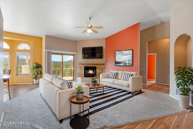 1330 Solar Heights Dr, Prescott, AZ 86303 - living area with ceiling fan, wood finished floors, a stone fireplace, and baseboards