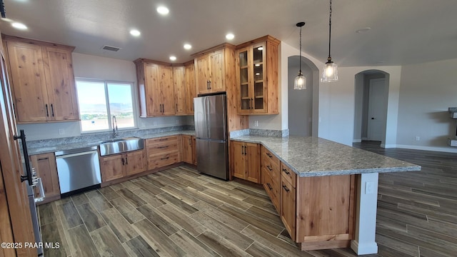 12880 E Brody Trl, Dewey-Humboldt, AZ 86327 - kitchen with stainless steel appliances, a peninsula, arched walkways, recessed lighting, and dark wood-style flooring