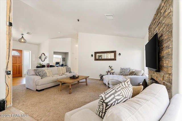 1520 Majestic Way, Prescott, AZ 86301 - living area with a stone fireplace, vaulted ceiling, light carpet, and baseboards