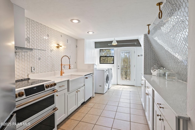 500 Broadview St, Prescott, AZ 86303 - kitchen featuring independent washer and dryer, stainless steel appliances, white cabinetry, light tile patterned floors, and wallpapered walls