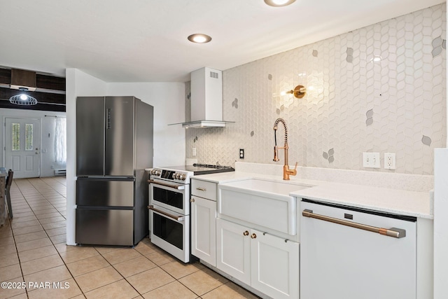 500 Broadview St, Prescott, AZ 86303 - kitchen featuring white appliances, wall chimney range hood, light tile patterned flooring, and white cabinetry