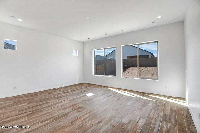 exercise room with hardwood / wood-style floors and ceiling fan