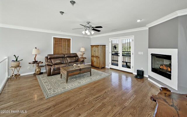 10190 N Prescott Ridge Rd, Prescott Valley, AZ 86315 - living room featuring a tile fireplace, crown molding, ceiling fan, and hardwood / wood-style flooring