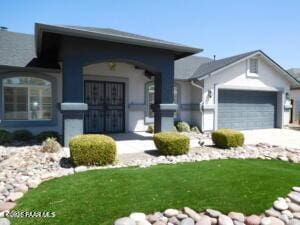 view of front of property with a front lawn and a garage