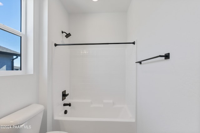 bathroom featuring shower / bathtub combination and toilet