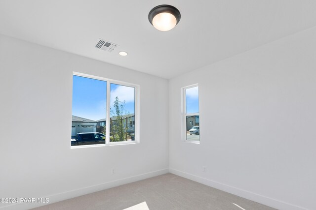 empty room featuring light colored carpet