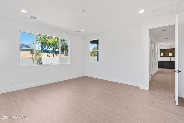 spare room featuring light hardwood / wood-style flooring