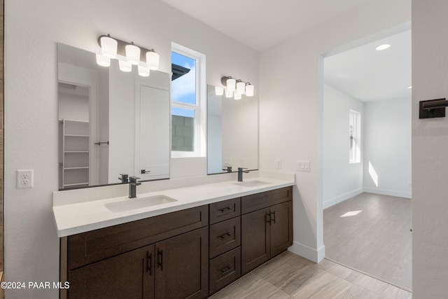 bathroom featuring a wealth of natural light, vanity, and hardwood / wood-style flooring