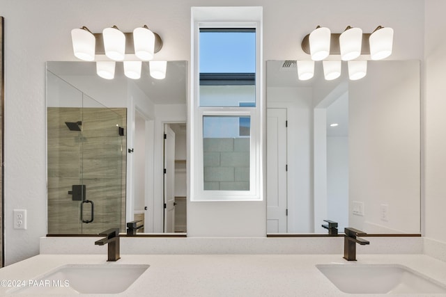 bathroom with vanity and a shower with shower door