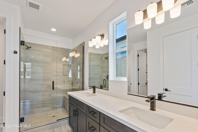 bathroom featuring hardwood / wood-style floors, vanity, and an enclosed shower