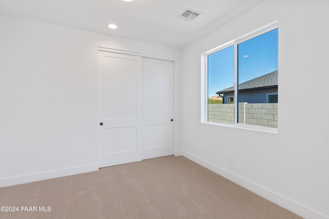 unfurnished bedroom featuring carpet floors and a closet