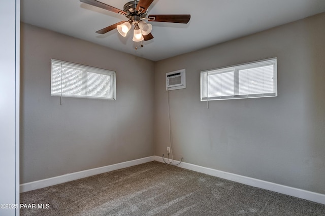 spare room with a wealth of natural light, carpet flooring, a ceiling fan, and baseboards