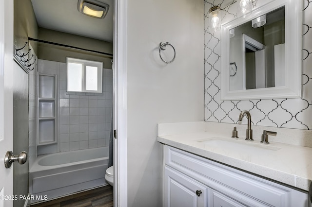 bathroom featuring shower / bath combination, toilet, vanity, and wood finished floors