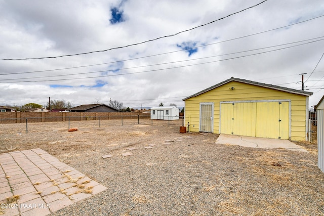 view of yard with an outdoor structure and fence