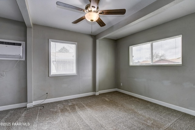 unfurnished bedroom featuring ceiling fan, a wall mounted air conditioner, baseboards, and carpet floors