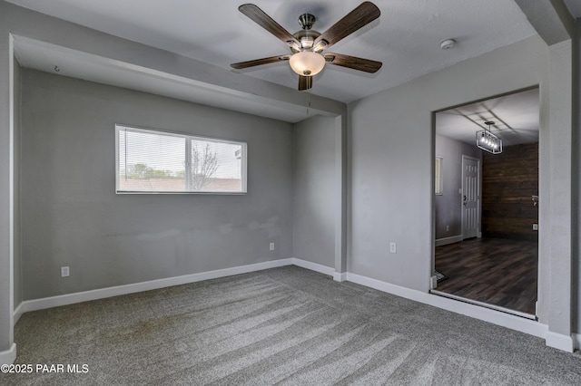 unfurnished bedroom featuring ceiling fan, baseboards, and carpet