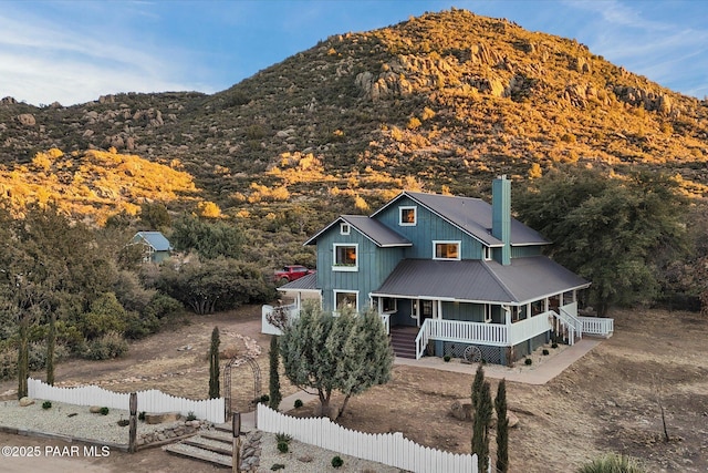 view of front facade featuring a mountain view and covered porch