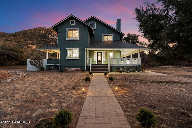 view of front of house featuring a mountain view and covered porch