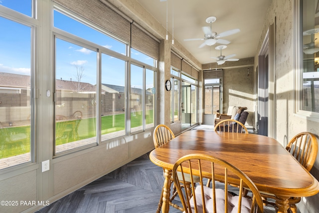 sunroom / solarium with ceiling fan and plenty of natural light