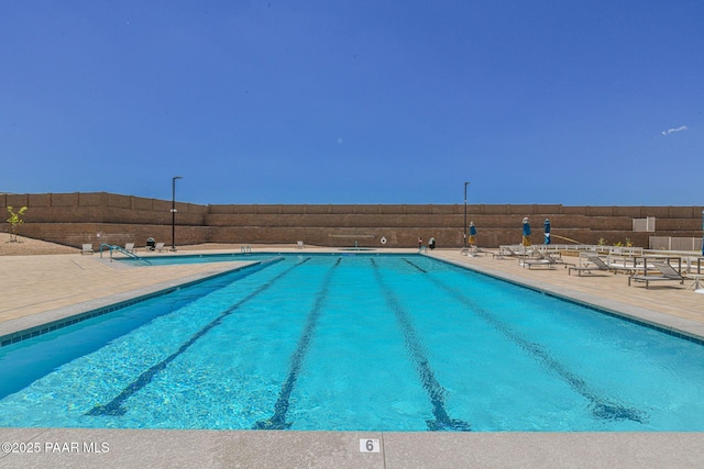 view of swimming pool with a patio area