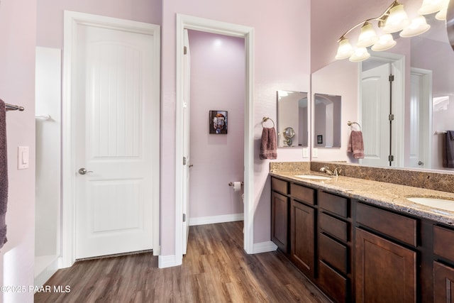 bathroom with hardwood / wood-style floors and vanity