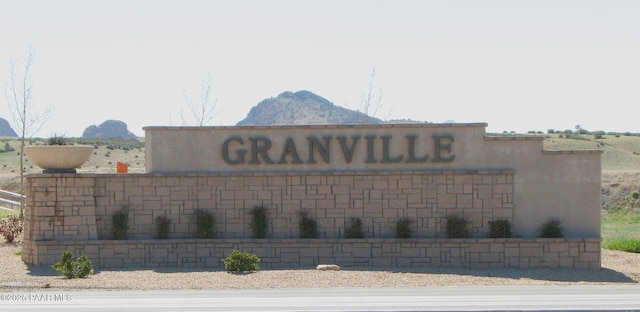 community sign with a mountain view