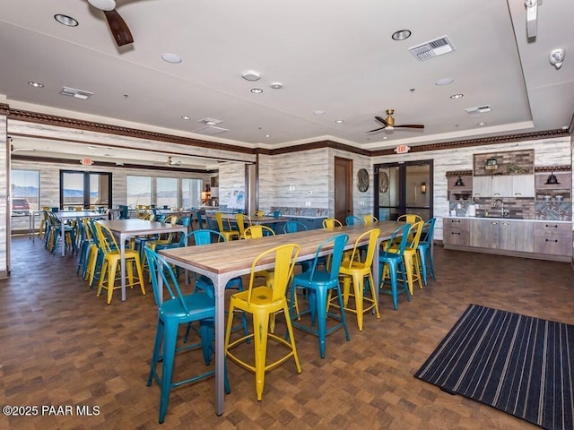 dining room featuring ceiling fan and crown molding