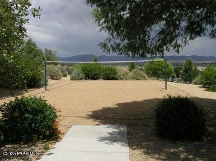 view of community with a mountain view and volleyball court