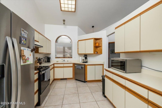 kitchen featuring light tile patterned flooring, sink, and stainless steel appliances